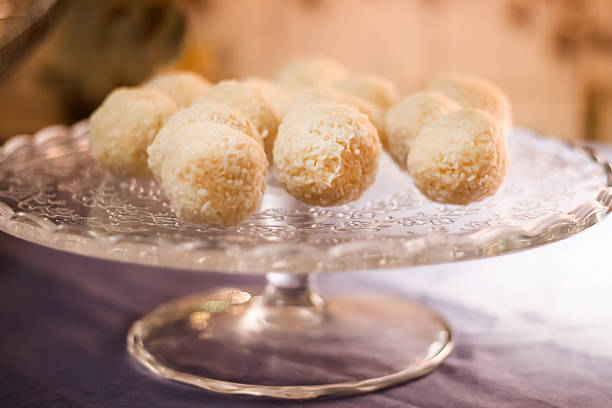 Cakes with coconut truffles in the evening light on a stand.