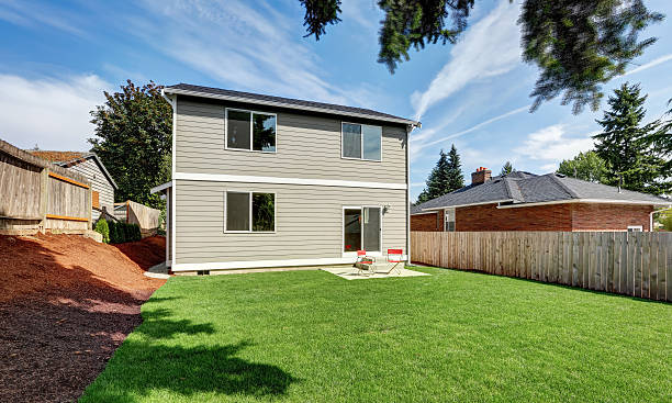 istock Fenced backyard garden filled with green grass 599126678
