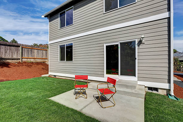 istock Fenced backyard garden filled with green grass 599126802