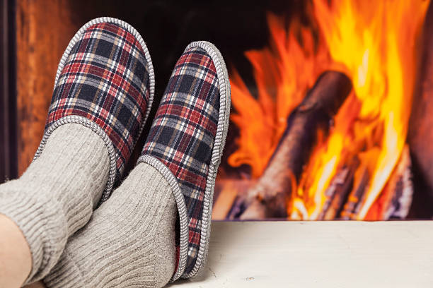 istock relaxing in slippers at fireplace white table 599126884