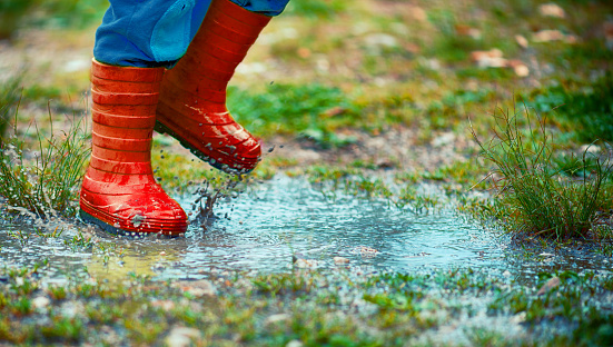 Child Jumping in a Puddle
