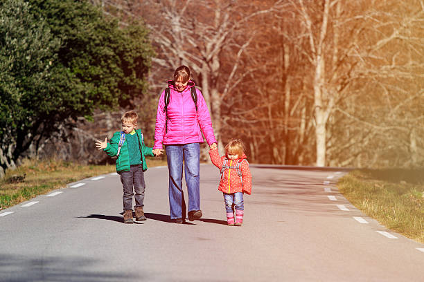 istock mother with two kids go to school 599127876