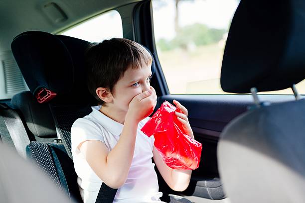 Seven years old child vomiting in car Seven years old child vomiting in car - suffers from motion sickness nausea photos stock pictures, royalty-free photos & images