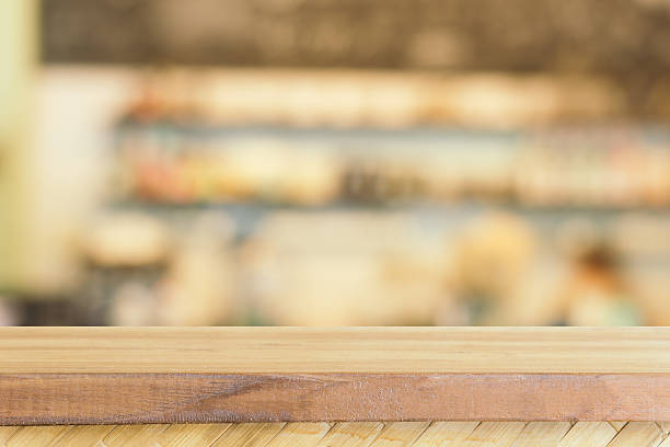 istock Wooden board empty table blur in coffee shop. 599131078