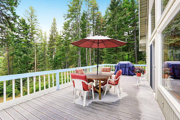 istock Wooden walkout deck . Furnished with red chairs and table 599131900