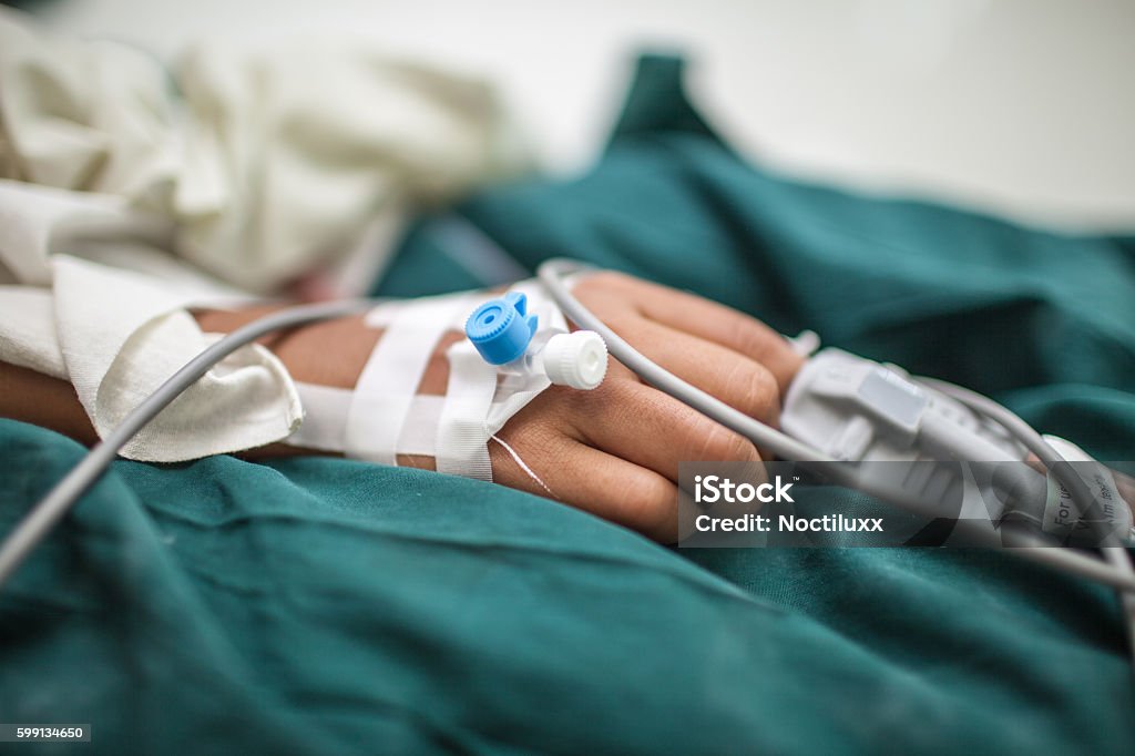 Close-up of an IV blood transfusion Intravenous blood infusion with tubes and bandages before an operation Infused Oil Stock Photo