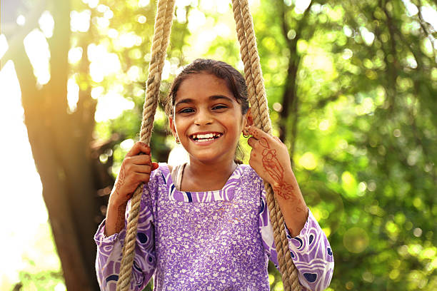 istock Little girl swinging 599136966