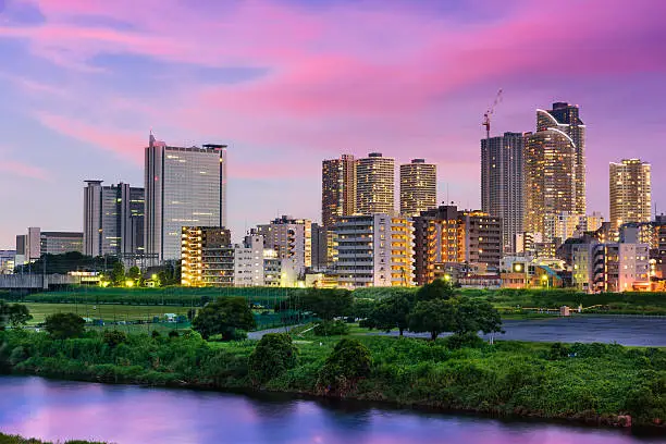 Kawasaki, Japan skyline at night on the Tamagawa River.