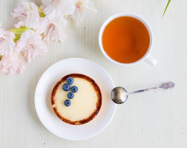 Cheese cake with blueberry and cup of tea, top view