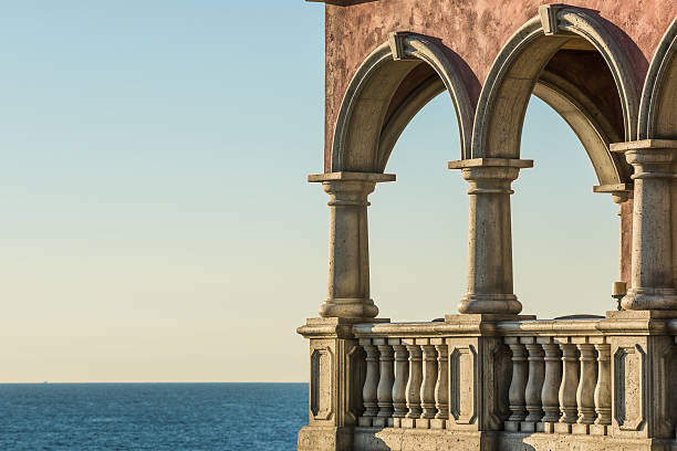 Italian architectural columns on balcony as beach house with pacific ocean view