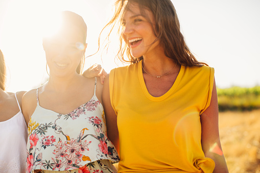 Three girlfriends having fun outside in nature