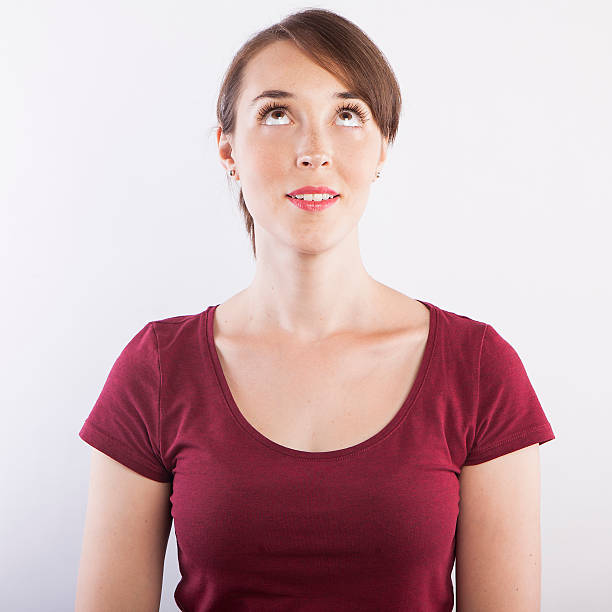 istock young beautiful woman looking up 599140618