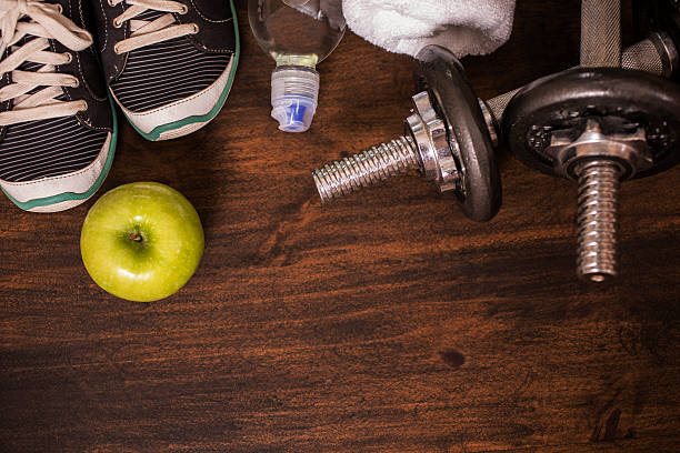 istock Fitness, exercise themed scene with weights, sneakers, apple. 599141502