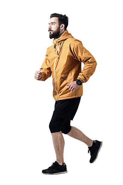 istock Side view of athletic man jogging in jacket looking up 599144192