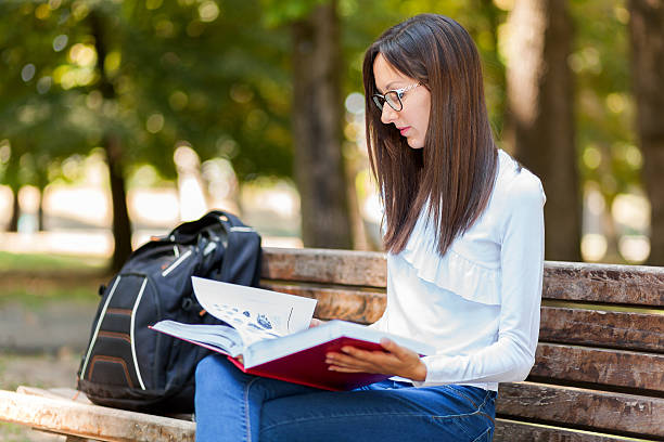 istock Young woman studying at the park 599144998