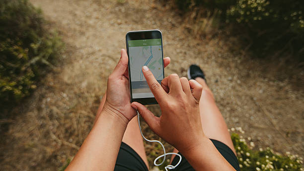 istock Female runner using a fitness app on her mobile phone 599146096