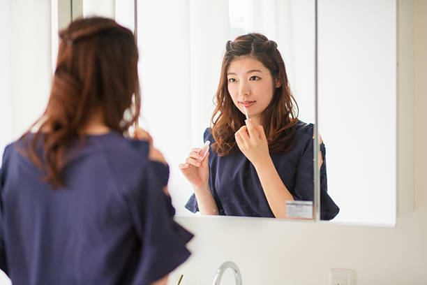 istock Young woman putting on make up 599146436
