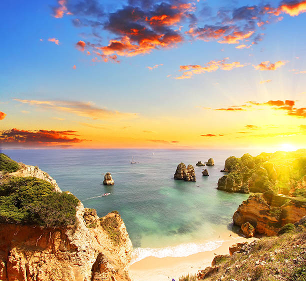 Rocky beach at sunset, Lagos, Portugal Rocky beach at sunset, Lagos, Portugal. Counter light. Travel and business background alvor stock pictures, royalty-free photos & images