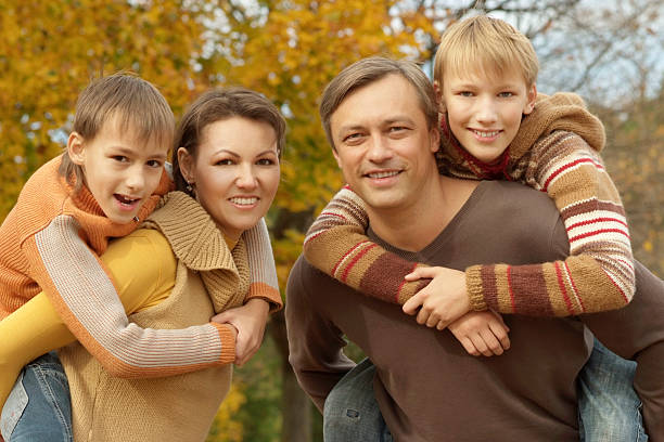 istock Happy family in autumn forest 599241836
