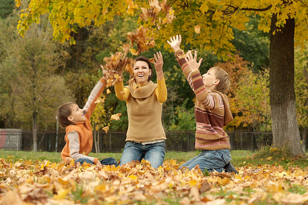 istock Mom with kids in park 599242454