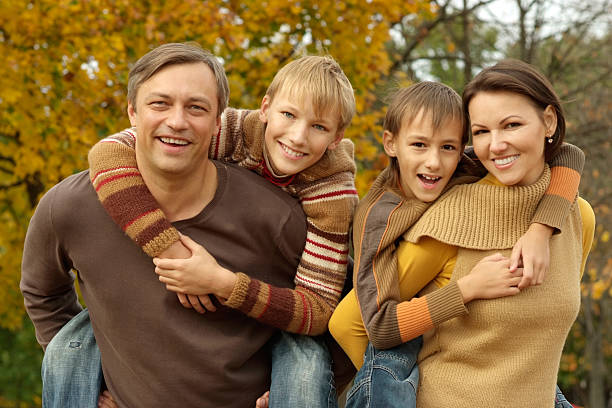 istock family relaxing in autumn park 599243674