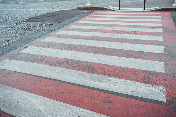 istock Red and white zebra crossing on a street 599245170