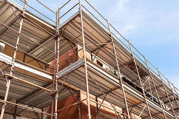 istock House for renovation with the scaffolding for bricklayers 599246544