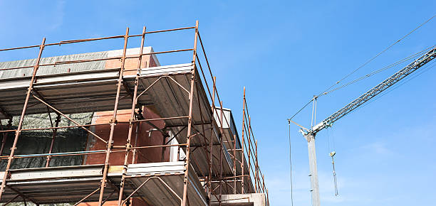 istock House for renovation with the scaffolding for bricklayers 599247522