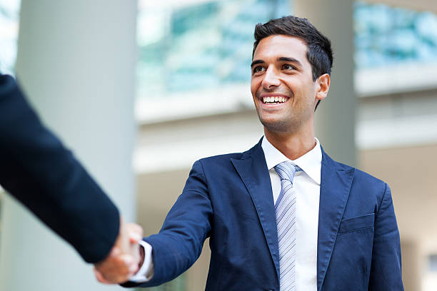 istock Businesspeople shaking hands outdoor 599250552