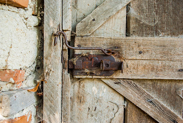 istock Old wood door with padlock 599252884
