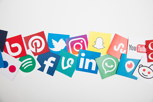London, United Kingdom - September 5, 2016: Popular social media logos printed onto paper. Social media apps and websites allow people to communicate and share within virtual global communities
