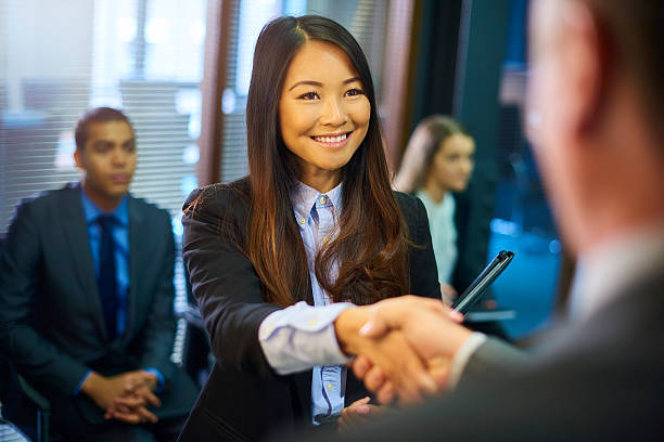 young woman's job interview - asian ethnicity suit business men imagens e fotografias de stock