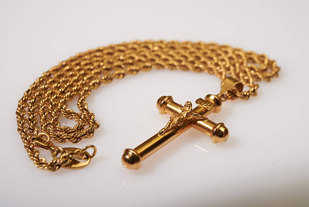 istock gold cross and chain on white background 599258828