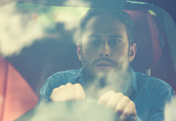 istock shocked scared funny looking young driver in car 599263830