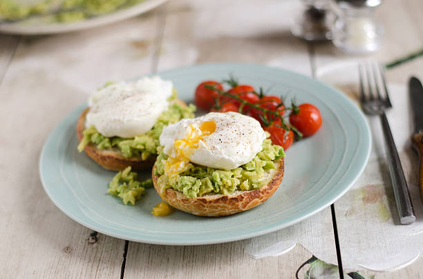 Poached eggs and avocado on toast stock photo