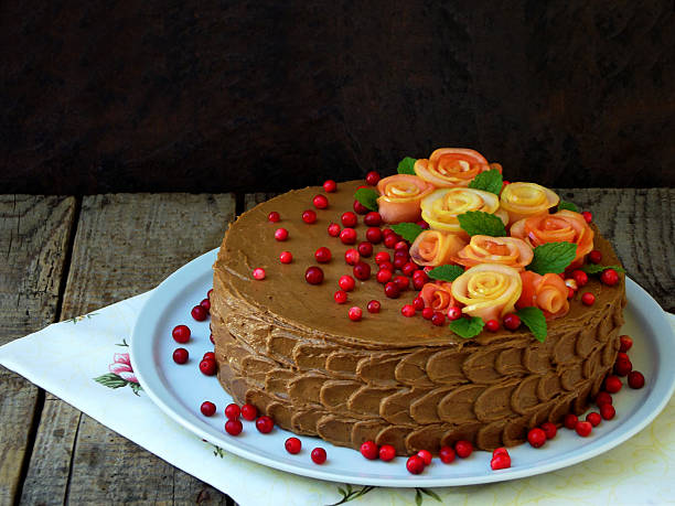istock chocolate cake with roses made from apples and cranberries 599267342