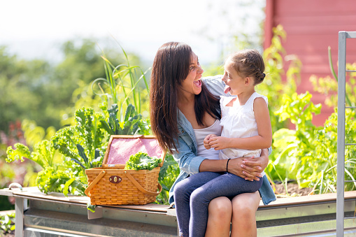 Mother and daughter enjoy gardening together outdoors