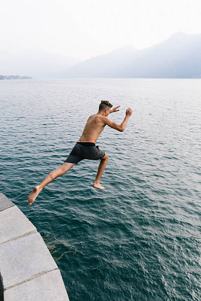 istock Jump in the water, Young man diving 599269478