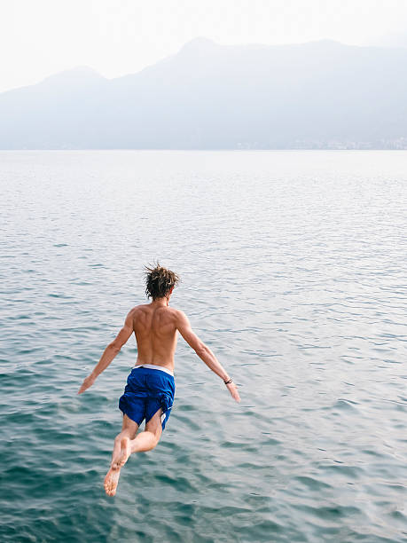 istock Young man diving in the water. 599269512