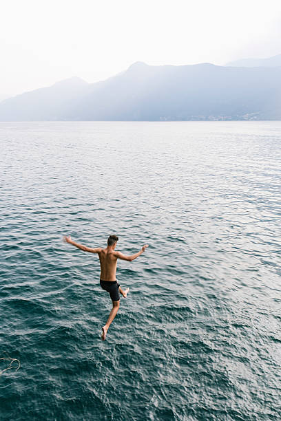 istock Jump in the water, Young man diving 599269516