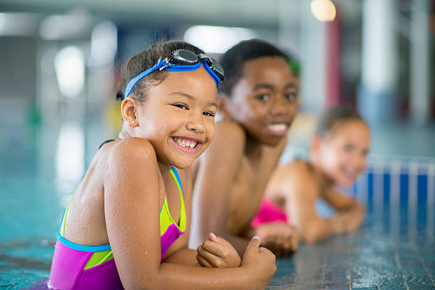 istock Children Happily Playing in the Pool 599273246