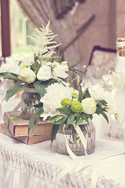 istock bouquet of white flowers. wedding table decor. 599274102