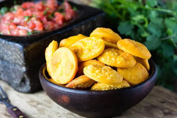 Photo of Latin American food. Traditional chilenian homemade pumpkin sopaipillas with salsa