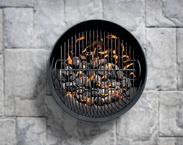 istock Charcoal BBQ on a Concrete Bick Patio 599275422