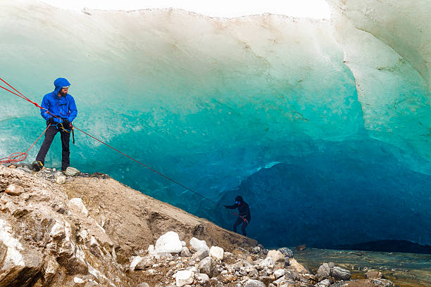 Rappelling into a glacial ice cave