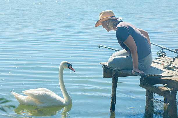 istock Woman and a swan 599276068