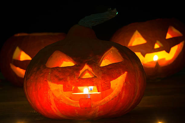 istock Scary halloween pumpkins on dark background 599278340