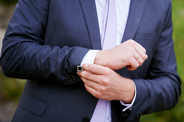 istock man in black jacket wears cuffs in park 599278534