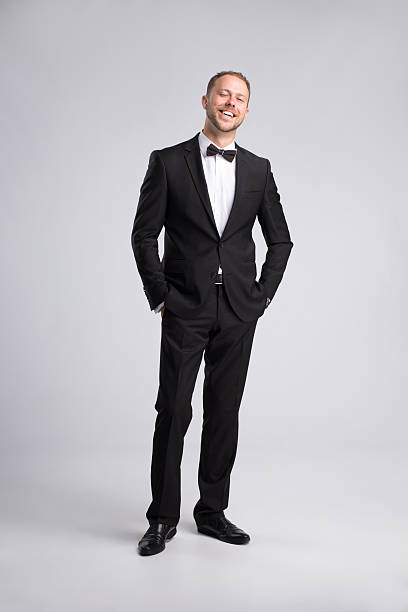 istock Smiling confident businessman in classic suit on gray background 599279340