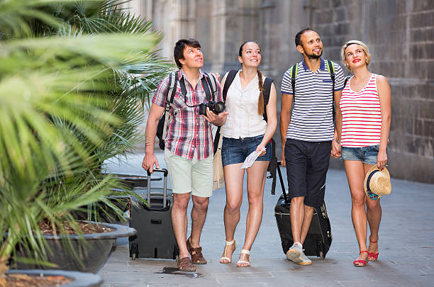 istock Couples with luggage walking the city 599280276